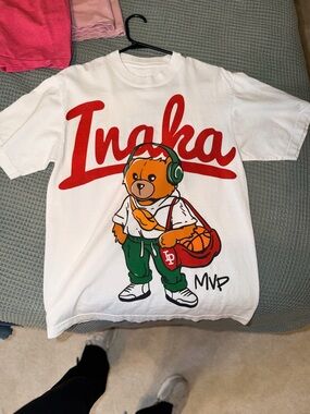 Inaka Power White Tee with Red Script and Orange Bear Graphic